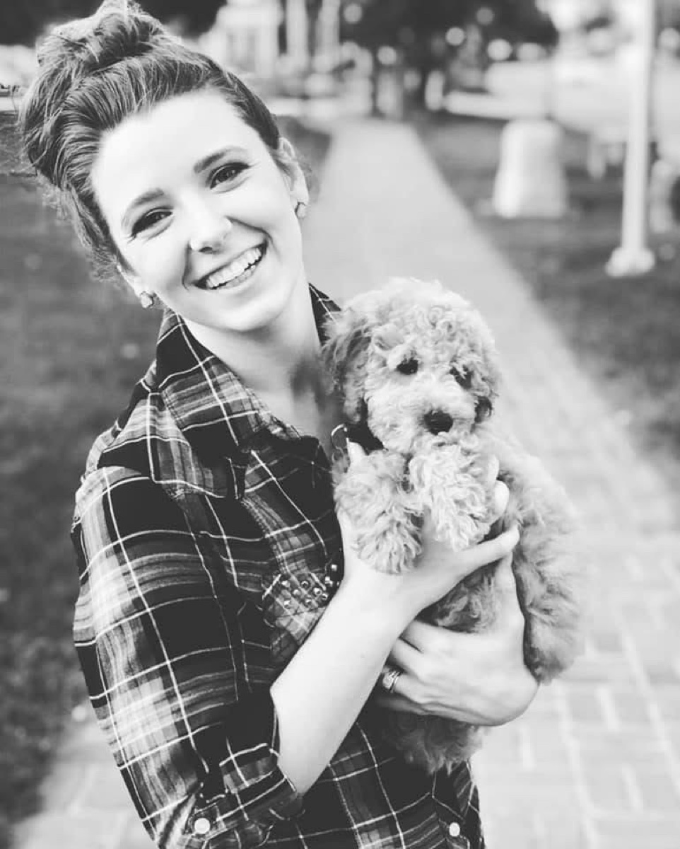 Kailee, founder of The Real Doodle Co., holding a doodle puppy